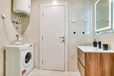 a bathroom with a washing machine and a sink at Twin Towers LT Luxury in Becici