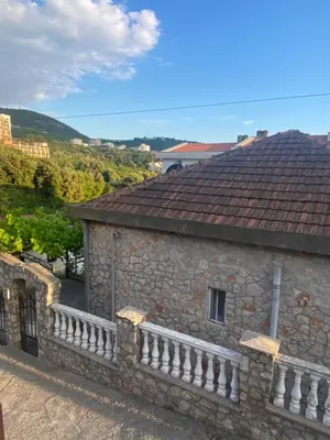 a view of a stone building with a tile roof at Little Stone House in Utjeha