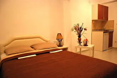 a bedroom with a large bed in a room at Apartmani Bonik in Budva