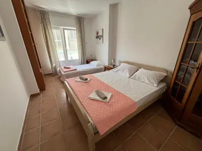 a bedroom with a large bed with a tray on it at Comfort Apartment El Mar in Sveti Stefan