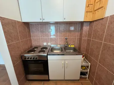 a small kitchen with a stove and a sink at Comfort Apartment El Mar in Sveti Stefan