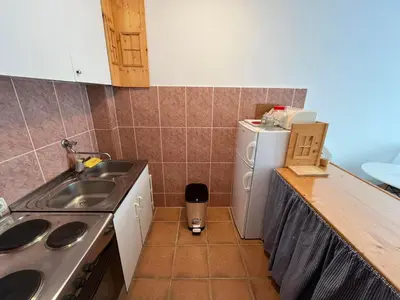 a small kitchen with a sink and a refrigerator at Comfort Apartment El Mar in Sveti Stefan