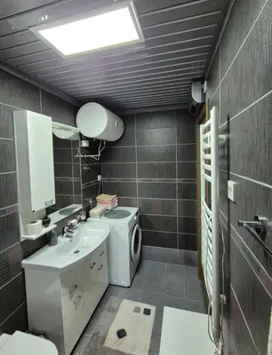 a bathroom with a toilet and a sink and a mirror at Petrovac in Petrovac na Moru