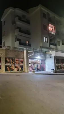 a store front of a building at night at Petrovac in Petrovac na Moru