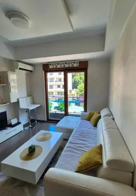 a living room with a couch and a table at Petrovac in Petrovac na Moru
