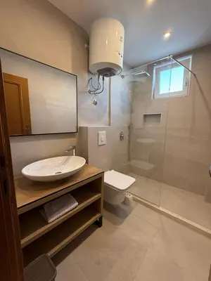 a bathroom with a sink and a toilet and a shower at Villa Firenze in Ulcinj