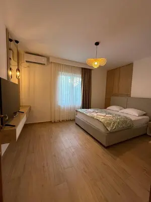 a large bedroom with a bed and a television at Villa Firenze in Ulcinj