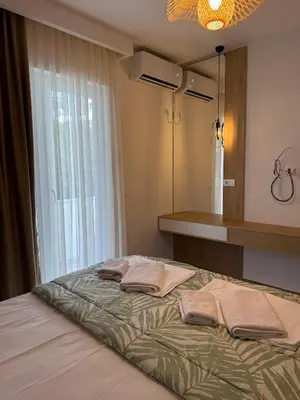 a bedroom with a bed with towels on it at Villa Firenze in Ulcinj