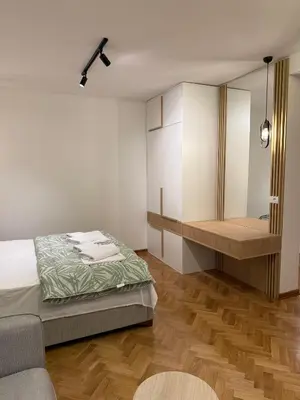 a bedroom with a bed and a vanity and a mirror at Villa Firenze in Ulcinj