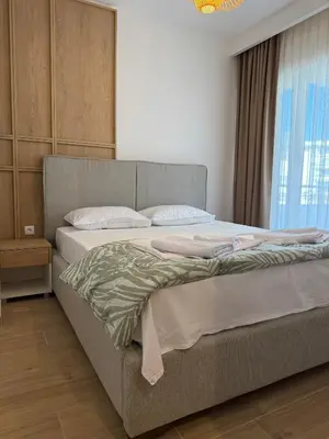 a large bed in a room with a window at Villa Firenze in Ulcinj