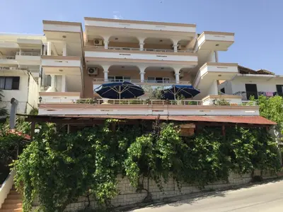 a building with umbrellas in front of it at Villa Firenze in Ulcinj