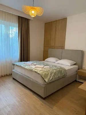 a bedroom with a large bed with a light at Villa Firenze in Ulcinj
