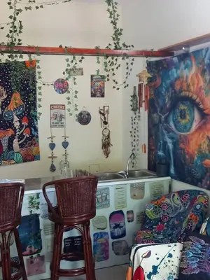 a living room with two chairs and a sink at Relax Hostel Bar in Podgorica