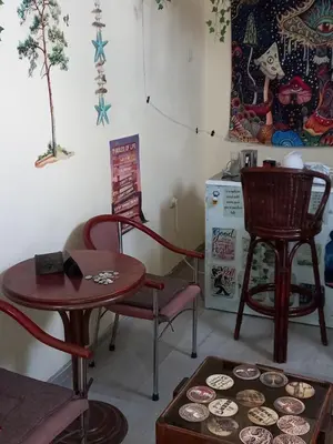 a room with two chairs and a table with cupcakes at Relax Hostel Bar in Podgorica