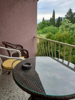 a table and chairs on a balcony with a view at Relax Hostel Bar in Podgorica
