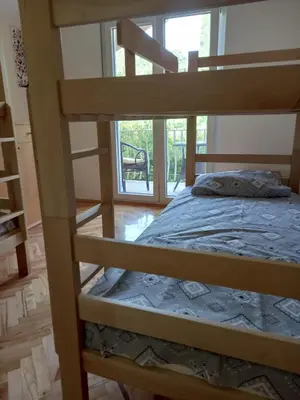 a bedroom with a bunk bed and a window at Relax Hostel Bar in Podgorica