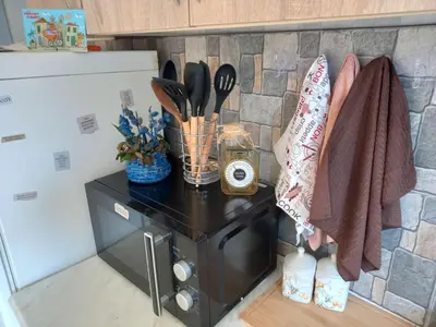 a counter in a kitchen next to a refrigerator at Relax Hostel Bar in Podgorica