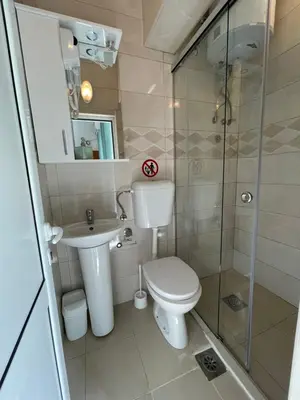 a bathroom with a toilet and a glass shower at Elsa in Ulcinj
