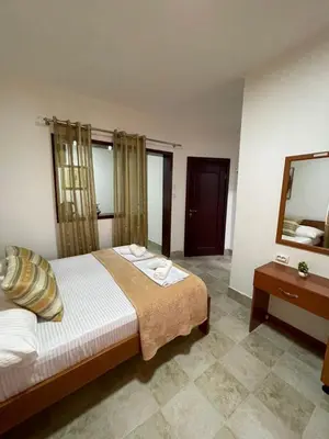 a hotel room with a bed and a mirror at Elsa in Ulcinj