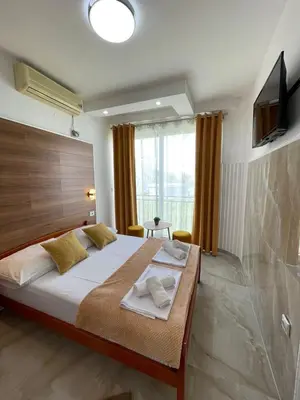 a bedroom with a large bed and a television at Elsa in Ulcinj