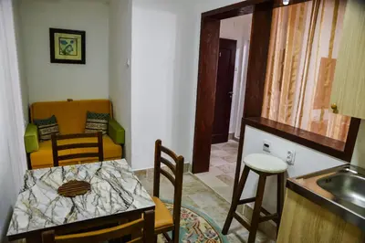 a kitchen and dining room with a table and chairs at Elsa in Ulcinj