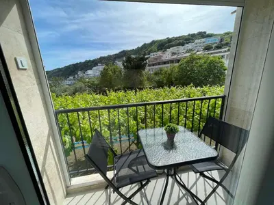 a table and two chairs on a balcony with a view at Elsa in Ulcinj