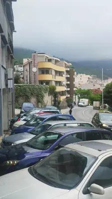 a row of cars parked in a parking lot at Sea View apartment in Budva in Budva