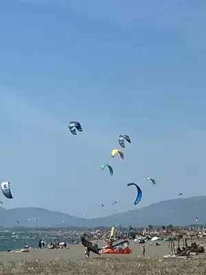 a group of people flying kites on a beach at Sea View apartment in Budva in Budva