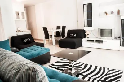 a living room with a couch and a table at Sea View apartment in Budva in Budva