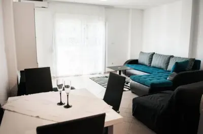 a living room with a table with wine glasses on it at Sea View apartment in Budva in Budva