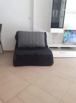 a couch sitting in front of a flat screen tv at Sea View apartment in Budva in Budva