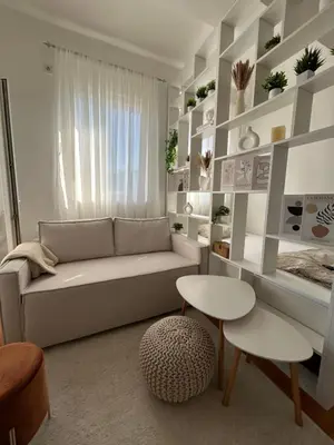 a living room with a couch and a table at Studio Soleil in Cetinje