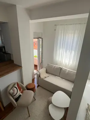 a living room with a couch and a chair at Studio Soleil in Cetinje
