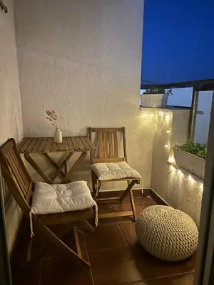 a patio with two chairs and a table on a balcony at Studio Soleil in Cetinje