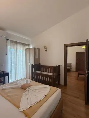 a bedroom with a large bed and a mirror at Apartments George in Ulcinj