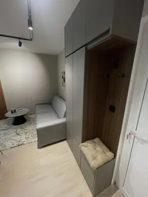 a small room with a couch and a cabinet at Apartmani Petrovac in Petrovac na Moru