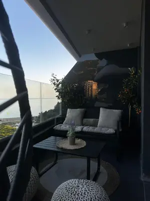 a room with a couch and a table on a balcony at ZOA Seaview Apartment in Becici