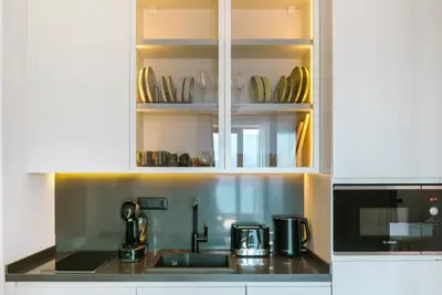 a kitchen with a sink and a coffee maker at ZOA Seaview Apartment in Becici