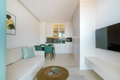 a living room with a white couch and a table at ZOA Seaview Apartment in Becici