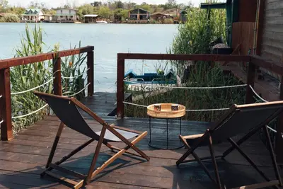 a couple of chairs and a table on a deck at River Breeze in Ulcinj