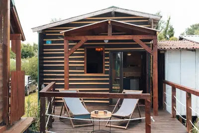 a cabin with two chairs and a table on a deck at River Breeze in Ulcinj
