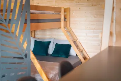 a room with a bunk bed with green pillows at River Breeze in Ulcinj