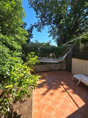 a patio with a hammock and a bench at Sunny Lemon Garden in Petrovac na Moru