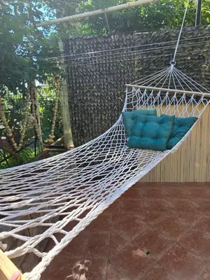 a hammock with a blue pillow on a patio at Sunny Lemon Garden in Petrovac na Moru