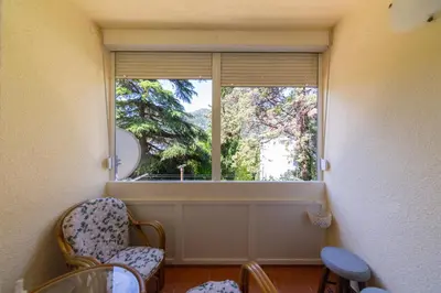 a room with a large window with chairs in front of it at KENOVA Apartment in Dobrota