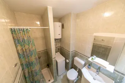 a bathroom with a toilet and a sink at KENOVA Apartment in Dobrota