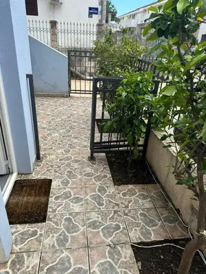 a patio with a bench and plants on a building at Apartman Vuk in Budva