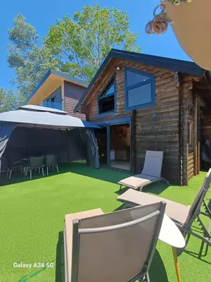 a home with a yard with chairs and a house at Mimas HOUSE ADA BOJANA in Ulcinj