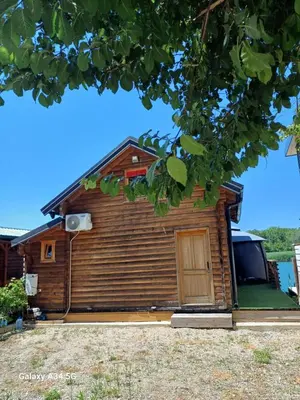 a log cabin with a door in front of it at Mimas HOUSE ADA BOJANA in Ulcinj
