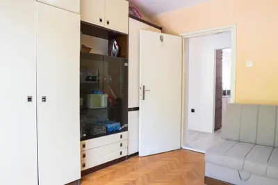 a room with a closet with white cabinets and a mirror at Central Apartment Dobrota II in Kotor
